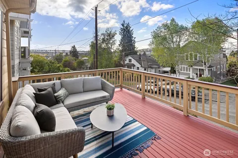 a balcony with wooden floor and a potted plant
