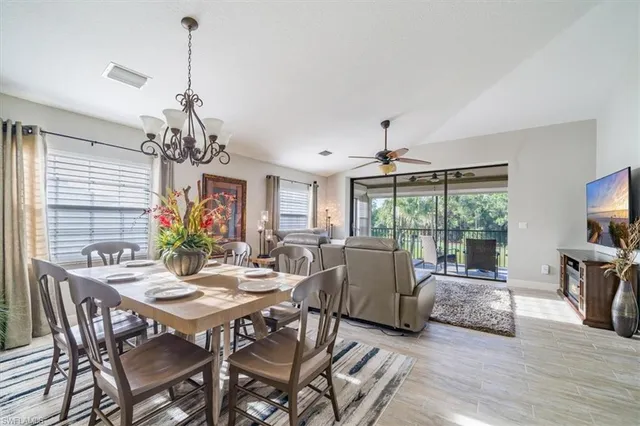 a view of a dining room with furniture wooden floor and chandelier