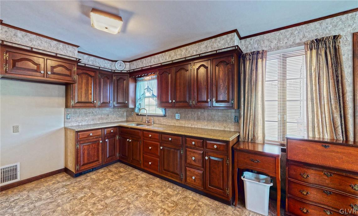 2229 Hillside Road Slatington, PA 18080 - Photo 7 of 35 a kitchen with stainless steel appliances granite countertop wooden cabinets a sink and dishwasher a oven with wooden cabinets