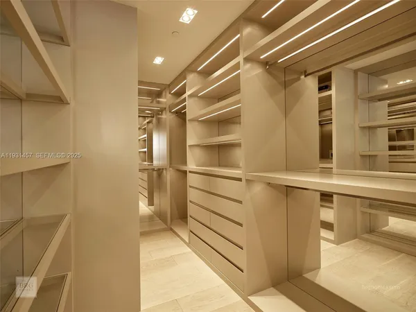 a view of walk in closet with empty racks