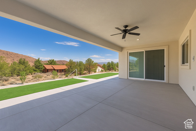 230 Boulder Way Leeds, UT 84746 - Photo 48 of 72 View of rear covered patio / terrace featuring a mountain view and ceiling fan.Concrete sidewalks surround the home.