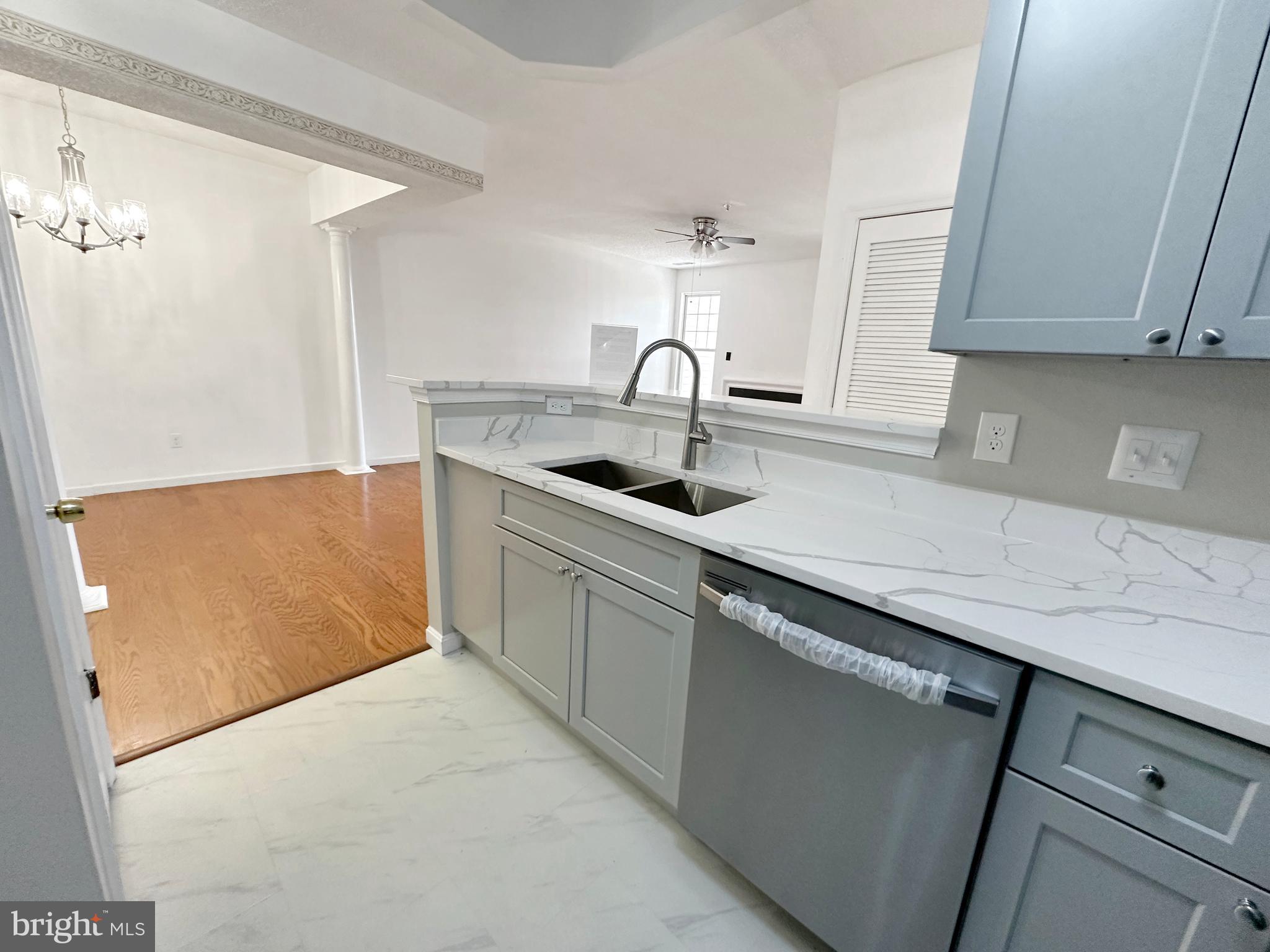 7205 Bogley Road, Unit 202 Baltimore, MD 21244 - Photo 3 of 11 a kitchen with a sink and cabinets