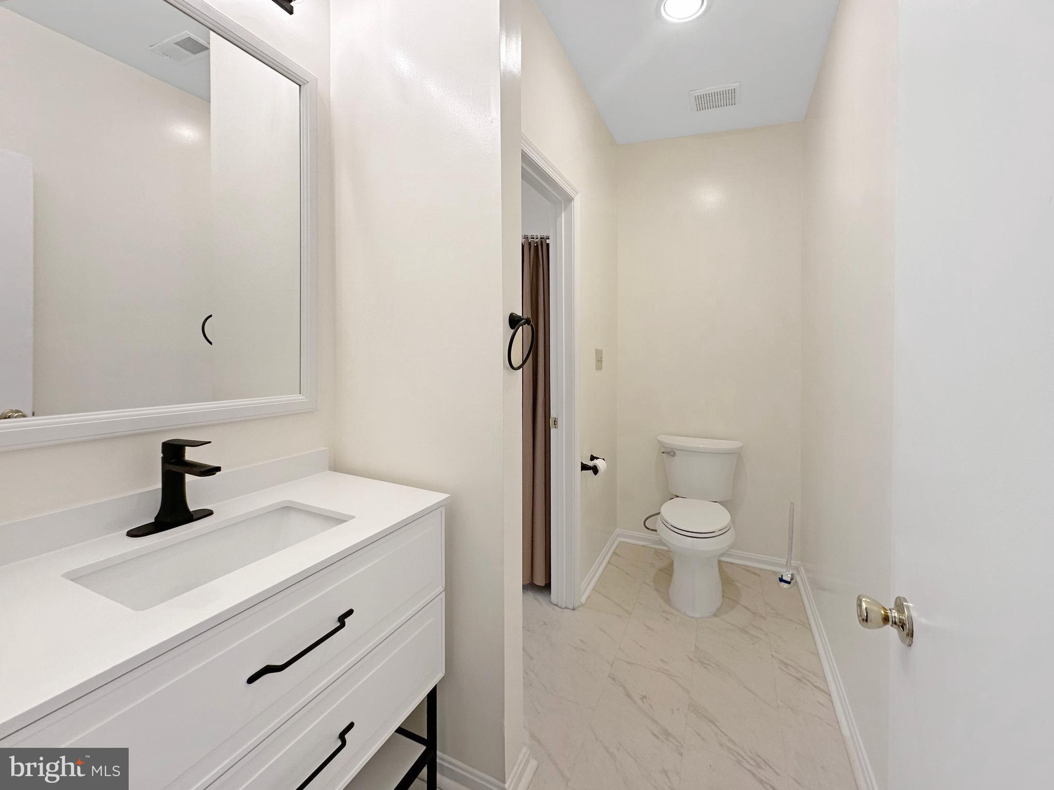 7205 Bogley Road, Unit 202 Baltimore, MD 21244 - Photo 5 of 11 a bathroom with a sink a toilet and shower