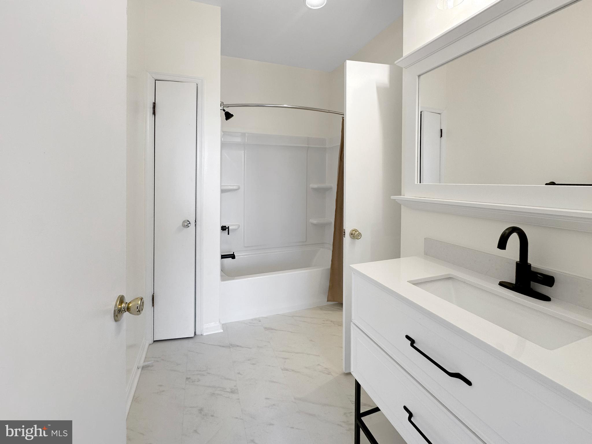 7205 Bogley Road, Unit 202 Baltimore, MD 21244 - Photo 6 of 11 a bathroom with a bathtub and a sink