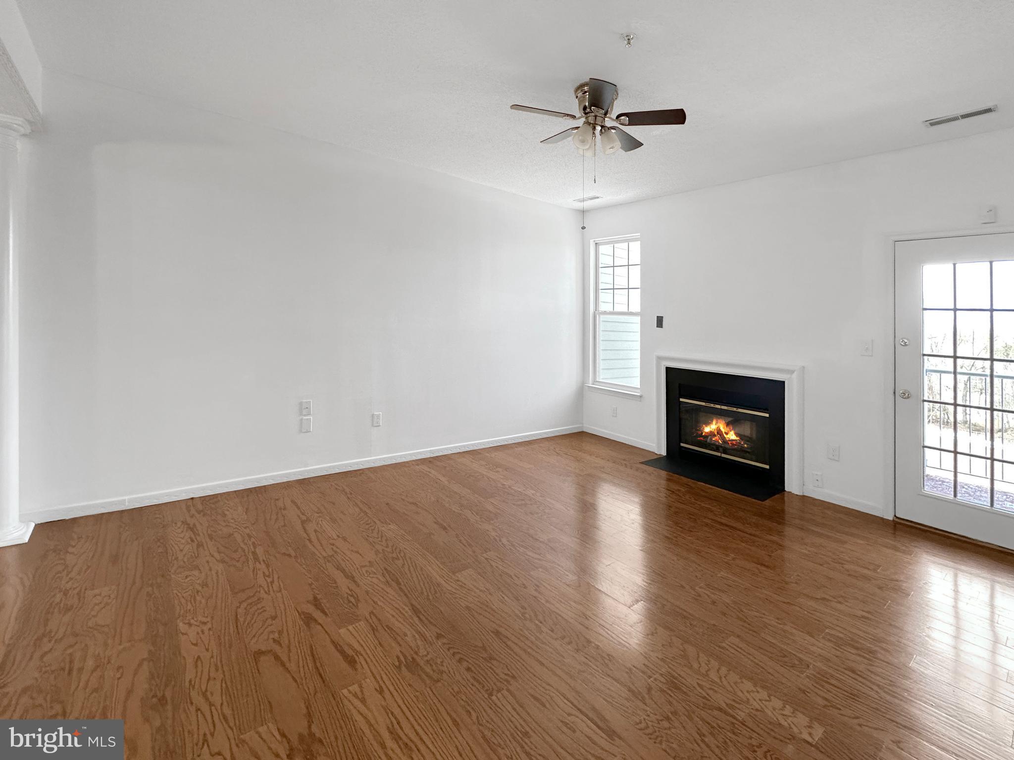 7205 Bogley Road, Unit 202 Baltimore, MD 21244 - Photo 9 of 11 wooden floor in an empty room with a window