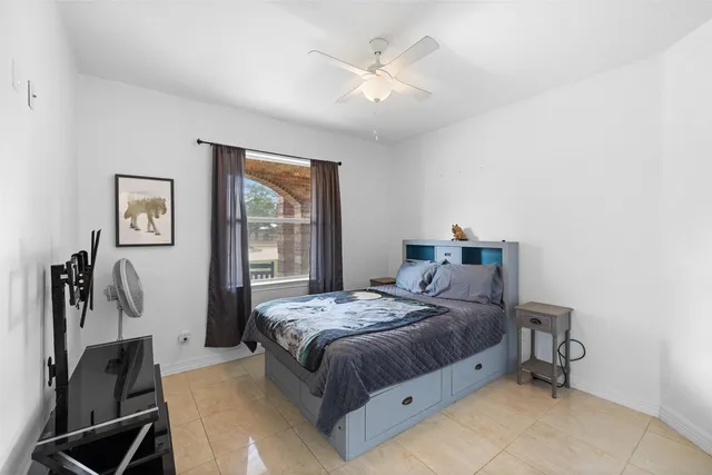 a bedroom with a bed and a painting on the wall