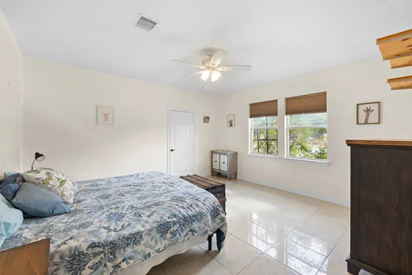 a bedroom with a large bed and a window