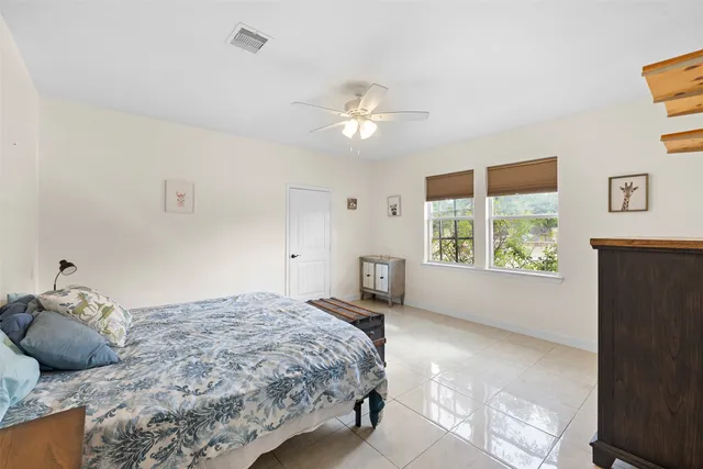 a bedroom with a large bed and a window