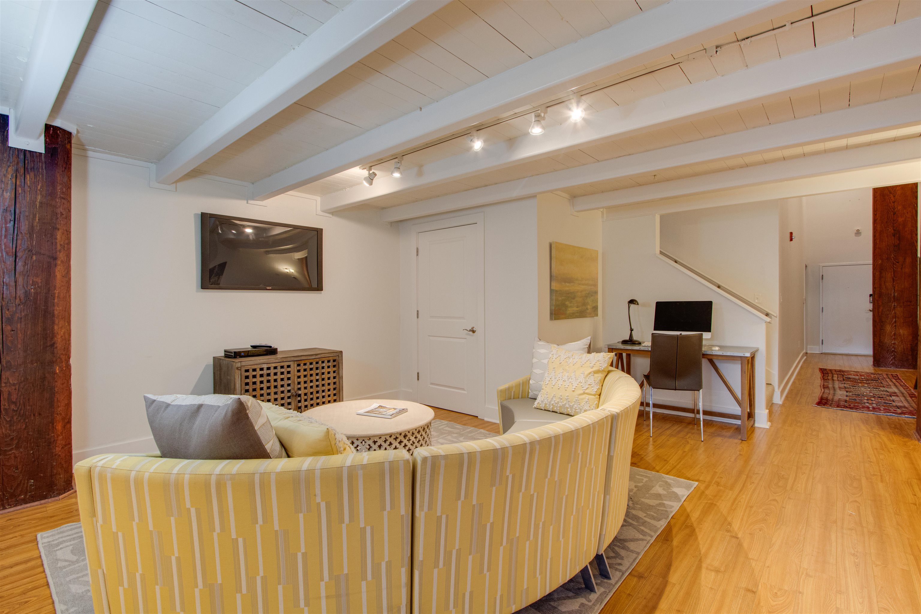 435 South Front Street, Unit 105 Memphis, TN 38103 - Photo 14 of 40 a living room with furniture and a flat screen tv