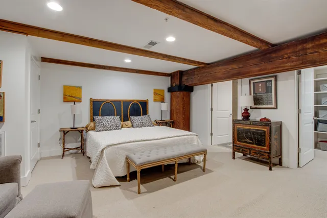 a bedroom with a bed and a tv