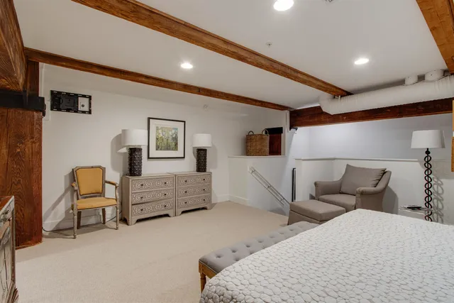 a bedroom with furniture and white walls