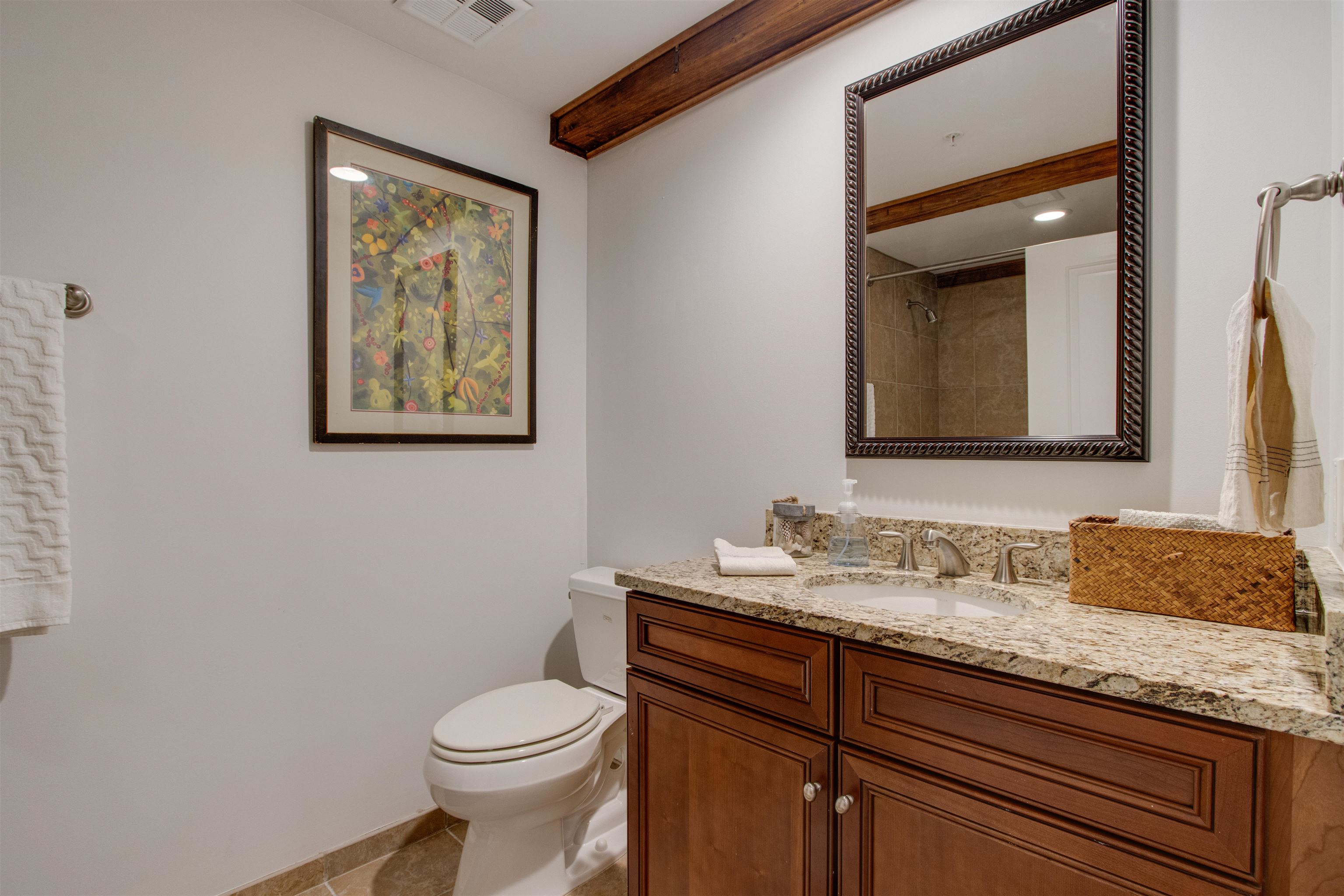 435 South Front Street, Unit 105 Memphis, TN 38103 - Photo 19 of 40 a bathroom with a granite countertop toilet sink and mirror
