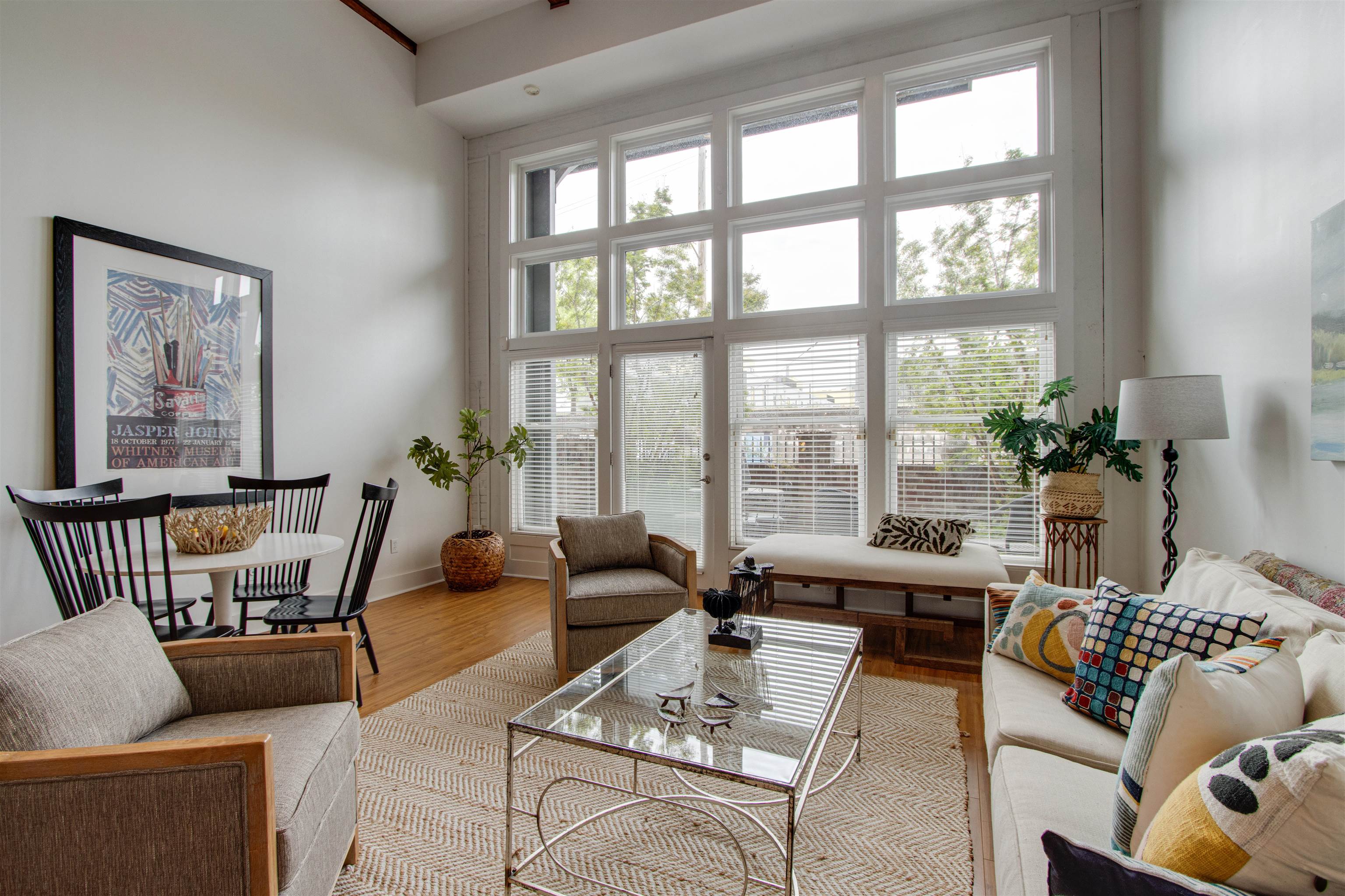435 South Front Street, Unit 105 Memphis, TN 38103 - Photo 3 of 40 a living room with furniture and floor to ceiling windows