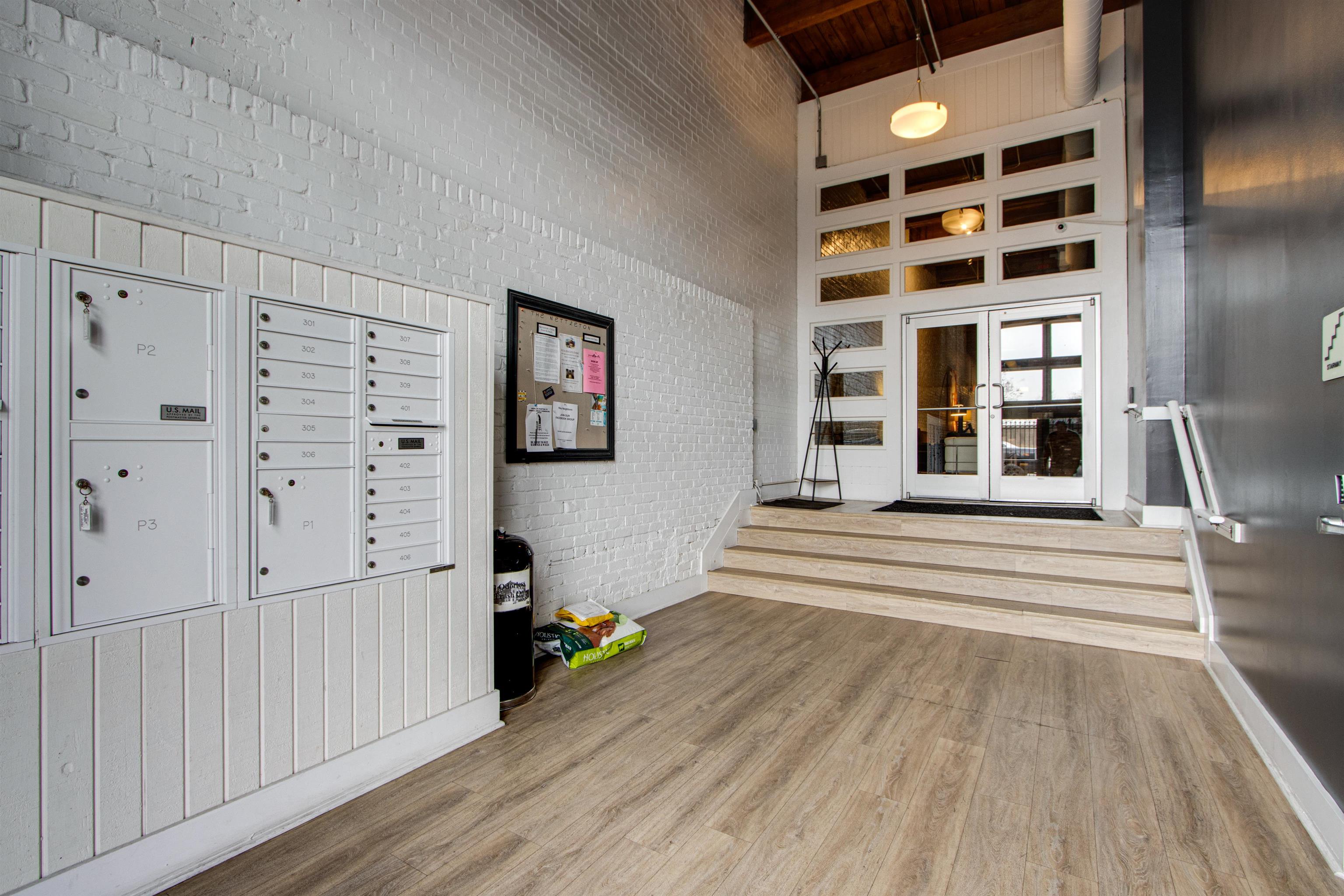435 South Front Street, Unit 105 Memphis, TN 38103 - Photo 36 of 40 a view of a bedroom with wooden floor and windows