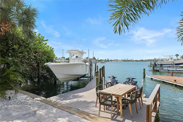 a balcony with a table and chairs