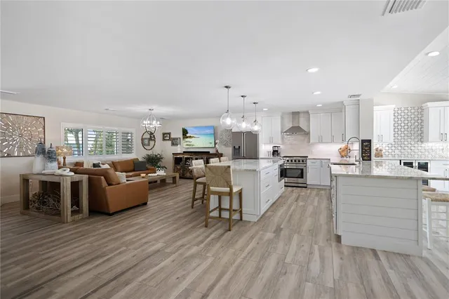 a living room with furniture and kitchen view