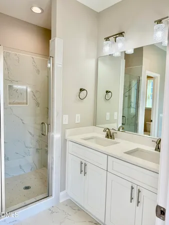 a bathroom with a shower sink and mirror
