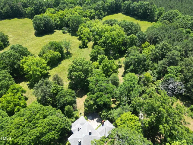 an aerial view of a house with mountain view