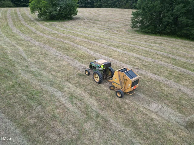 a view of a field of grass and trees
