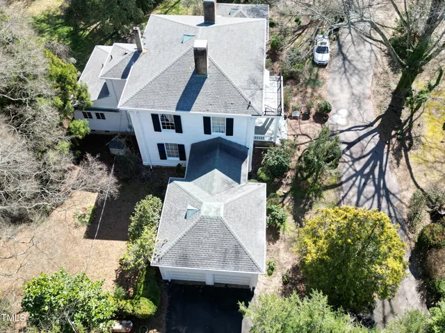 an aerial view of a house with a yard and garden