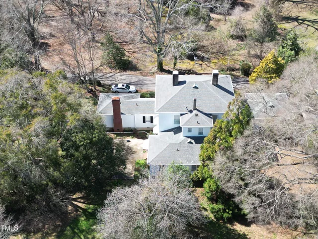 an aerial view of a house with yard and outdoor seating
