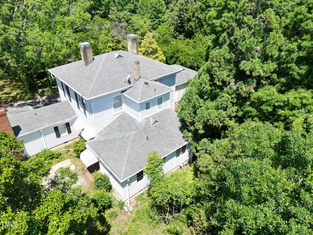 an aerial view of a house with a yard