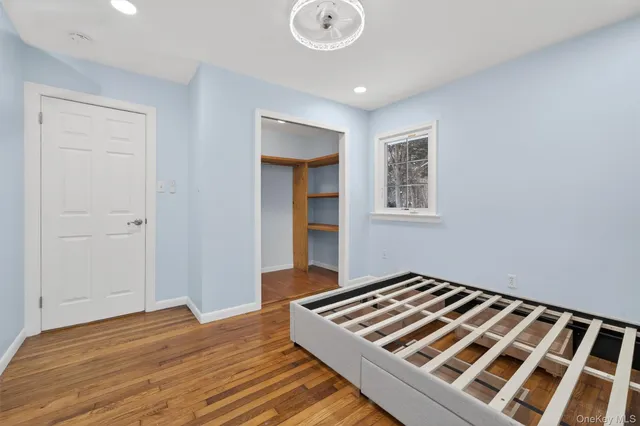 a bedroom with bed and window