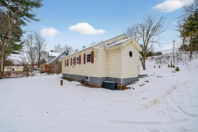 a view of a house with snow on the road