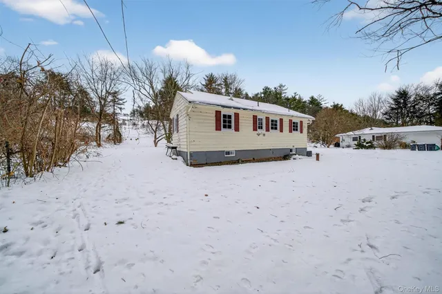a view of a house with a snow in the yard