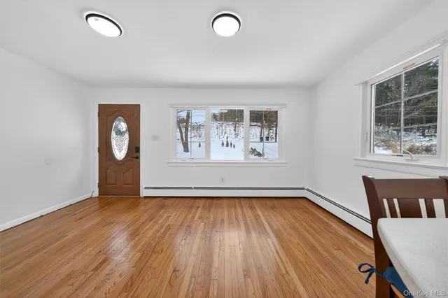 a view of a room with wooden floor and window