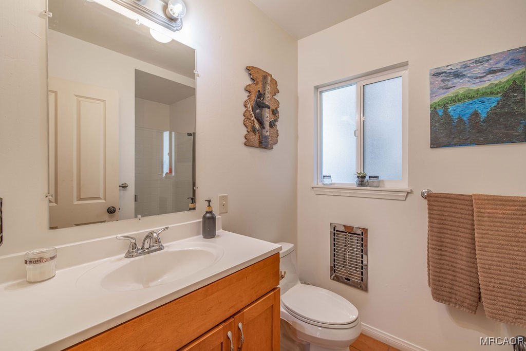 43411 Sheephorn Road Big Bear Lake, CA 92315 - Photo 17 of 50 a bathroom with a toilet a sink and mirror