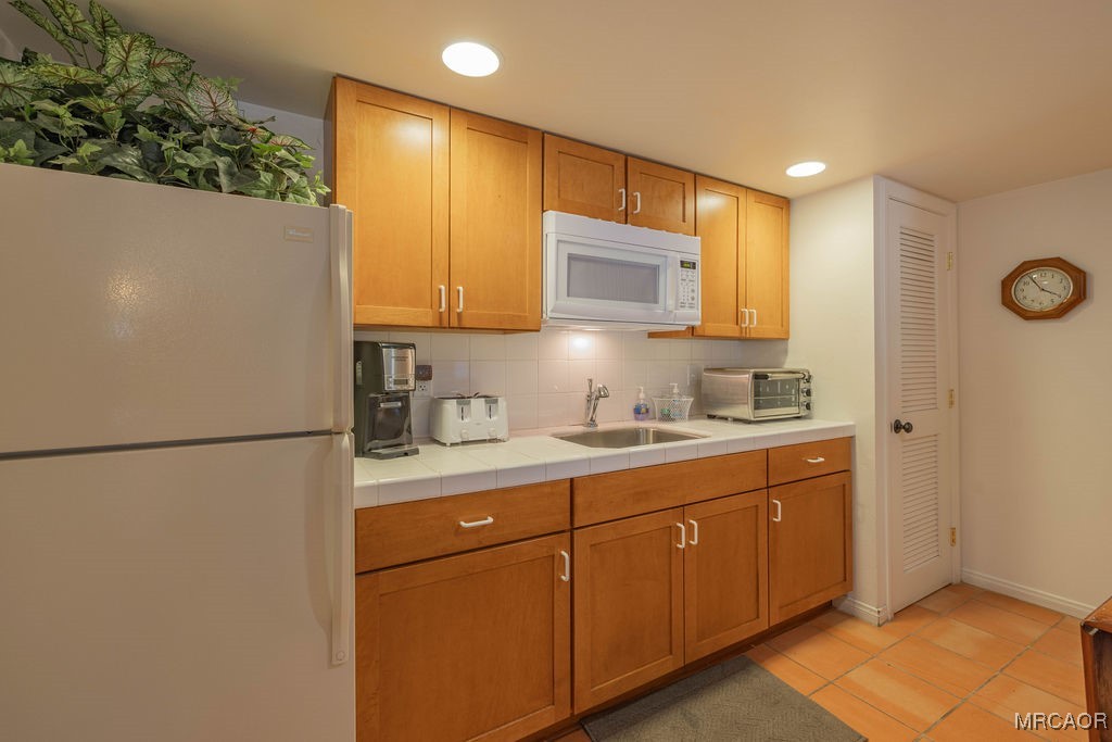 43411 Sheephorn Road Big Bear Lake, CA 92315 - Photo 37 of 50 a kitchen with a refrigerator sink and microwave