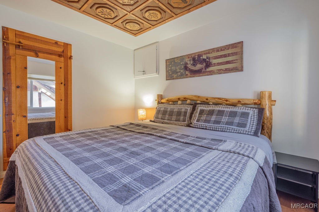 43411 Sheephorn Road Big Bear Lake, CA 92315 - Photo 42 of 50 a bedroom with a bed a dresser and next to a window