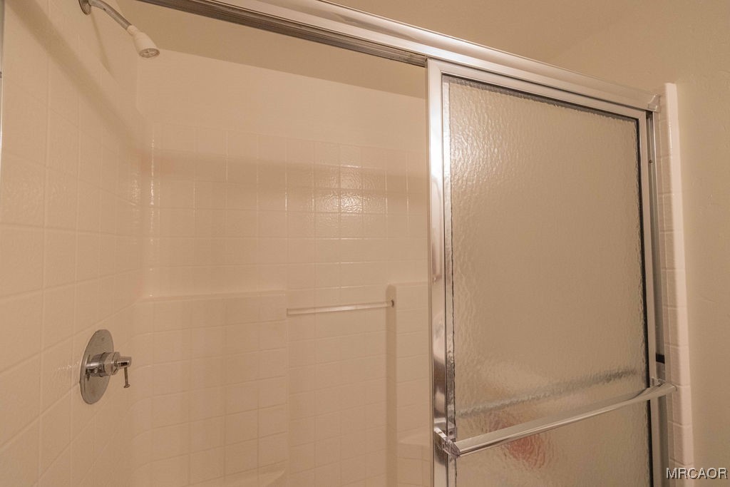 43411 Sheephorn Road Big Bear Lake, CA 92315 - Photo 44 of 50 a bathroom with a glass shower door