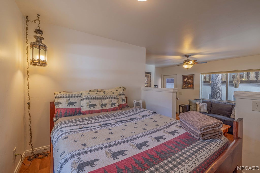 43411 Sheephorn Road Big Bear Lake, CA 92315 - Photo 46 of 50 a bedroom with a bed and a chandelier