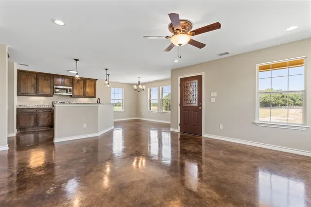 a view of a kitchen with a sink and stainless steel appliances