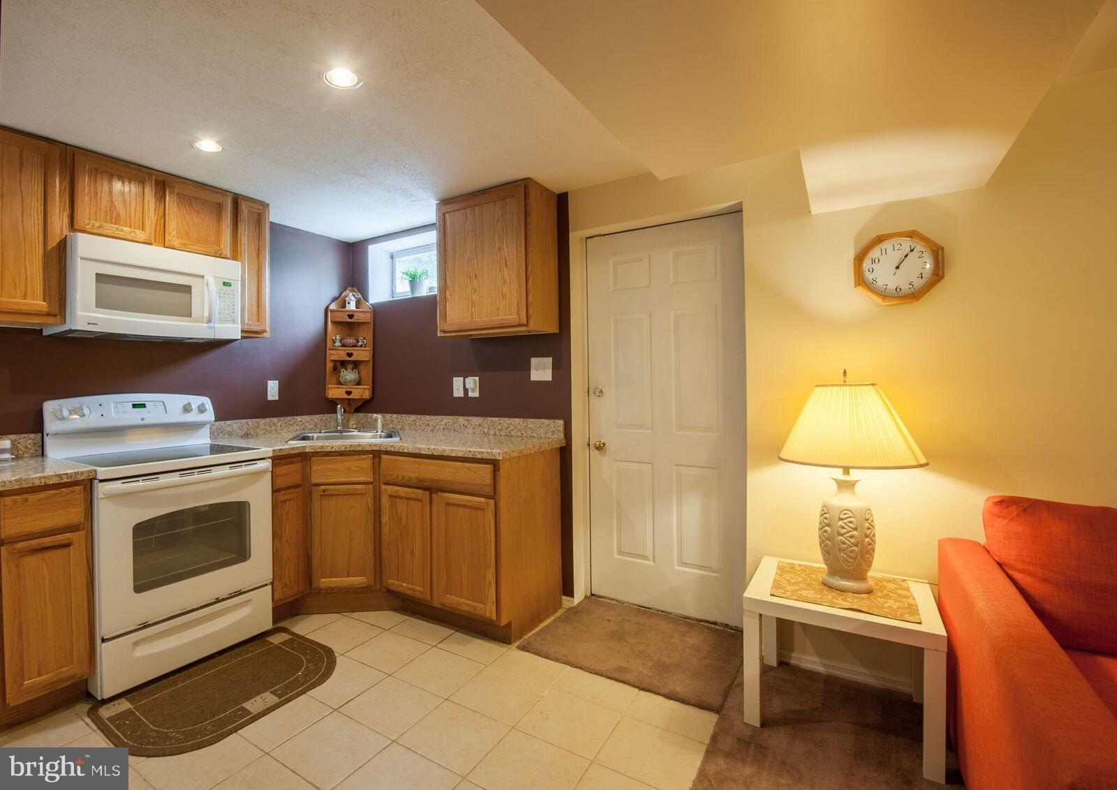 5106 Clifford Road Perry Hall, MD 21128 - Photo 23 of 30 a kitchen with a stove and a refrigerator