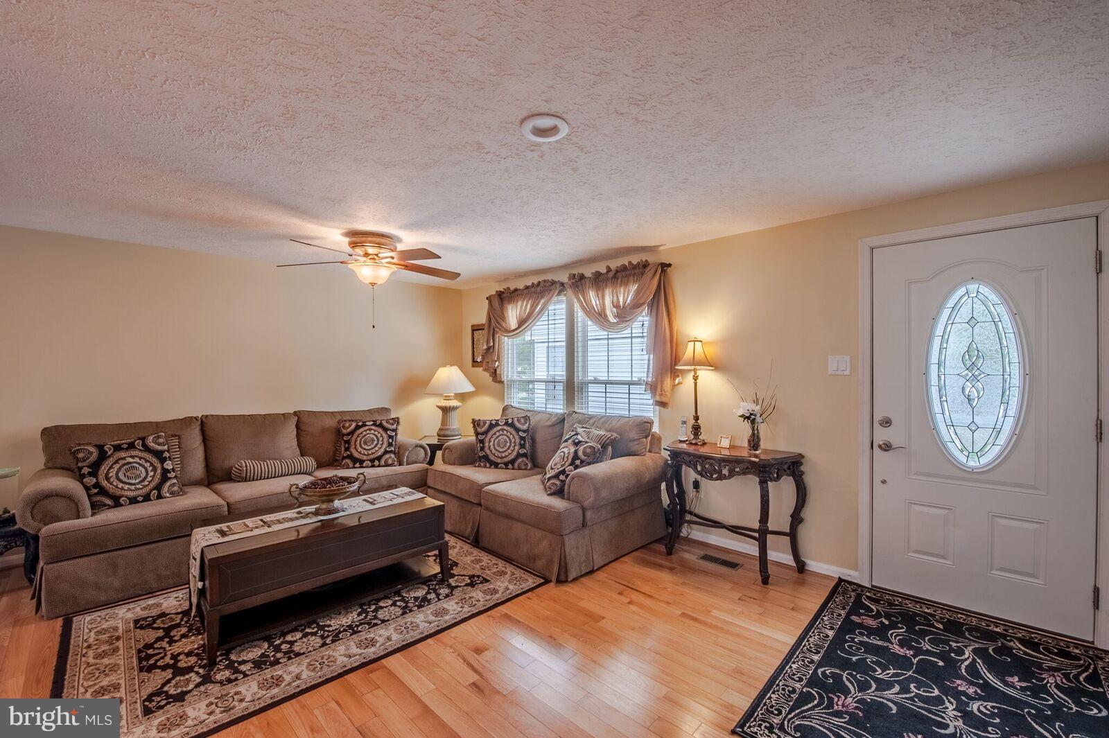 5106 Clifford Road Perry Hall, MD 21128 - Photo 10 of 30 a living room with furniture a clock on wall and a window
