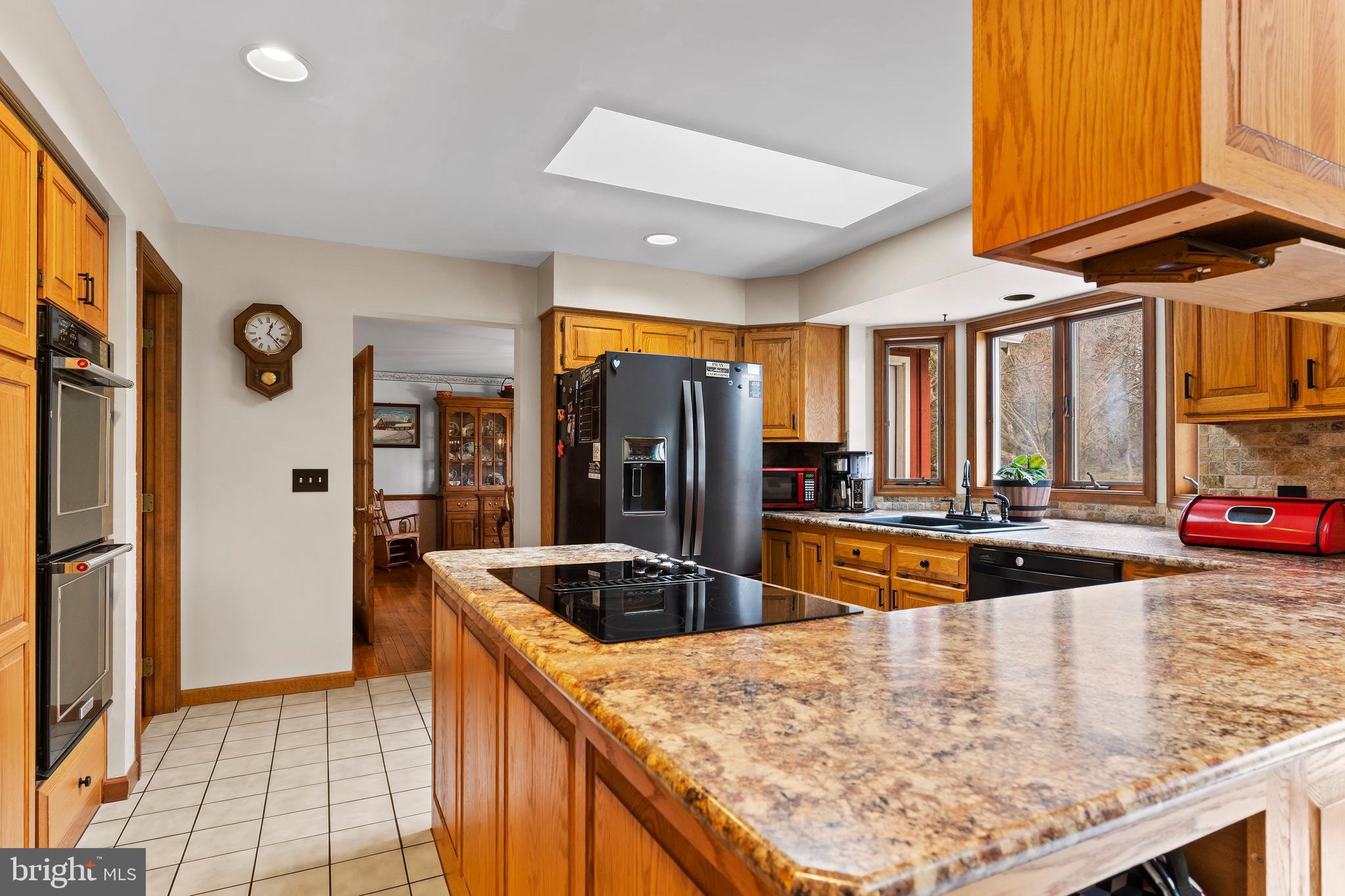 540 Springfield Road Newville, PA 17241 - Photo 16 of 59 a kitchen with stainless steel appliances granite countertop a sink and a refrigerator