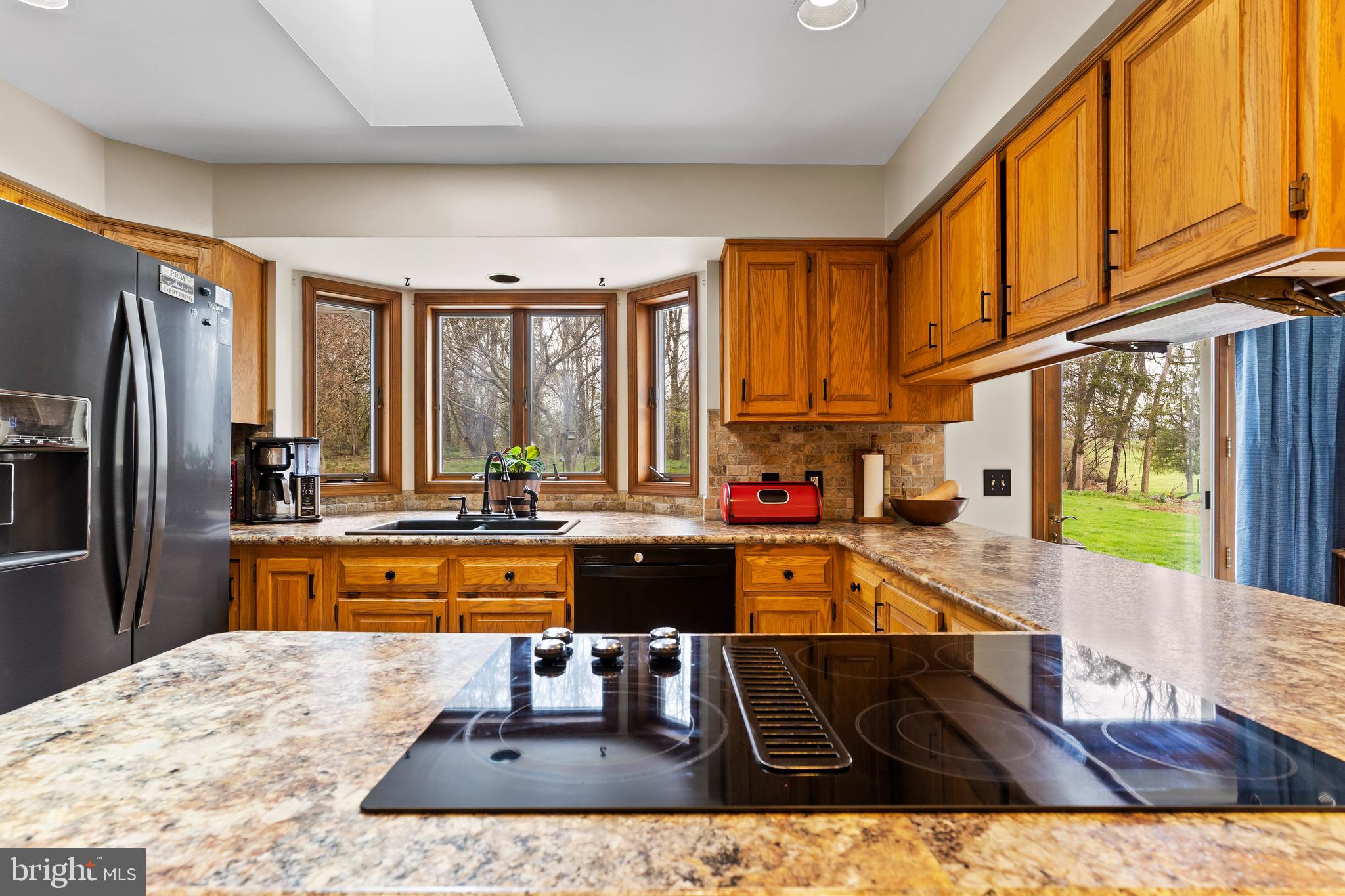 540 Springfield Road Newville, PA 17241 - Photo 18 of 59 a large kitchen with kitchen island granite countertop a large window and stainless steel appliances