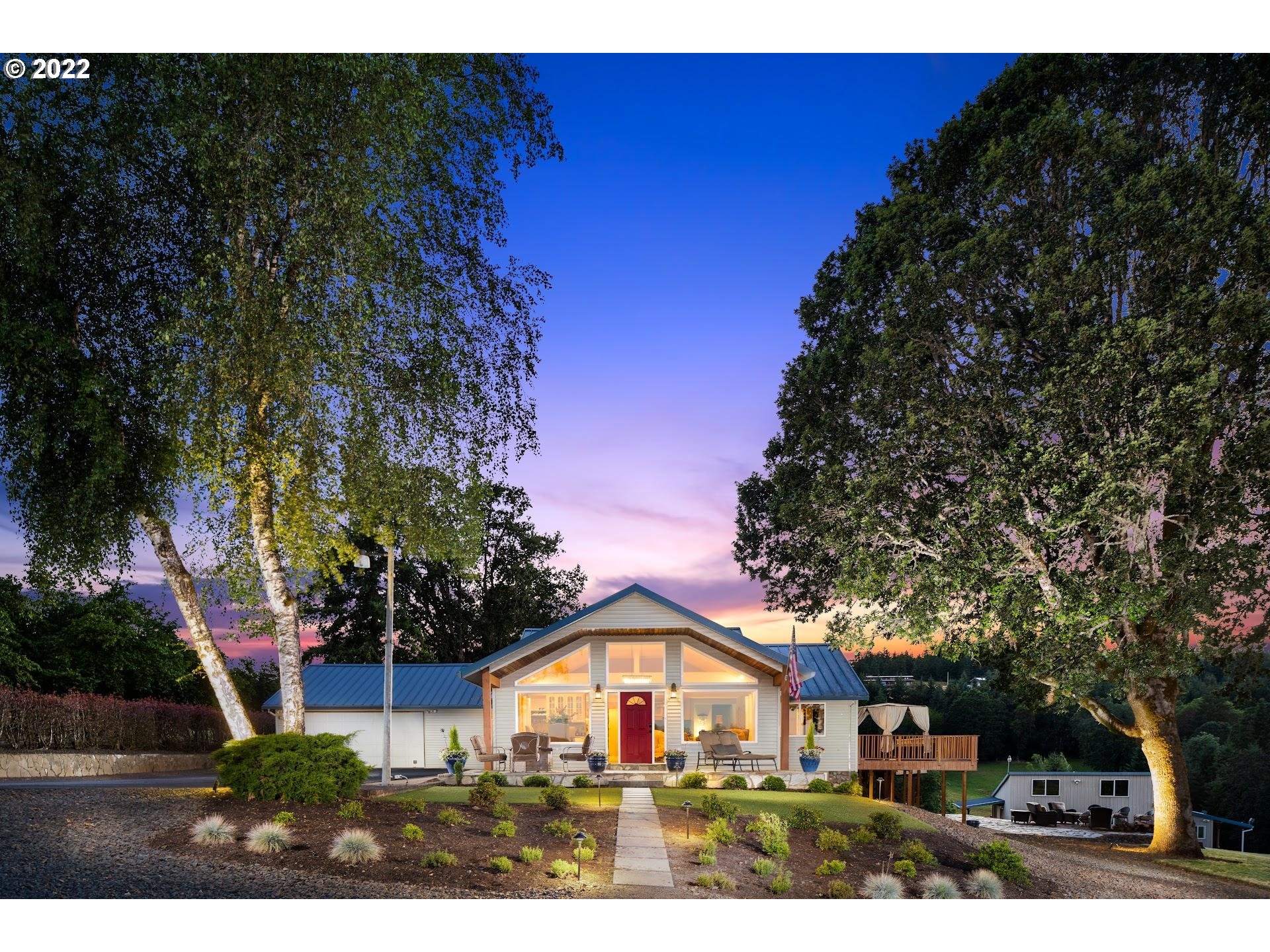 a front view of a house with a garden
