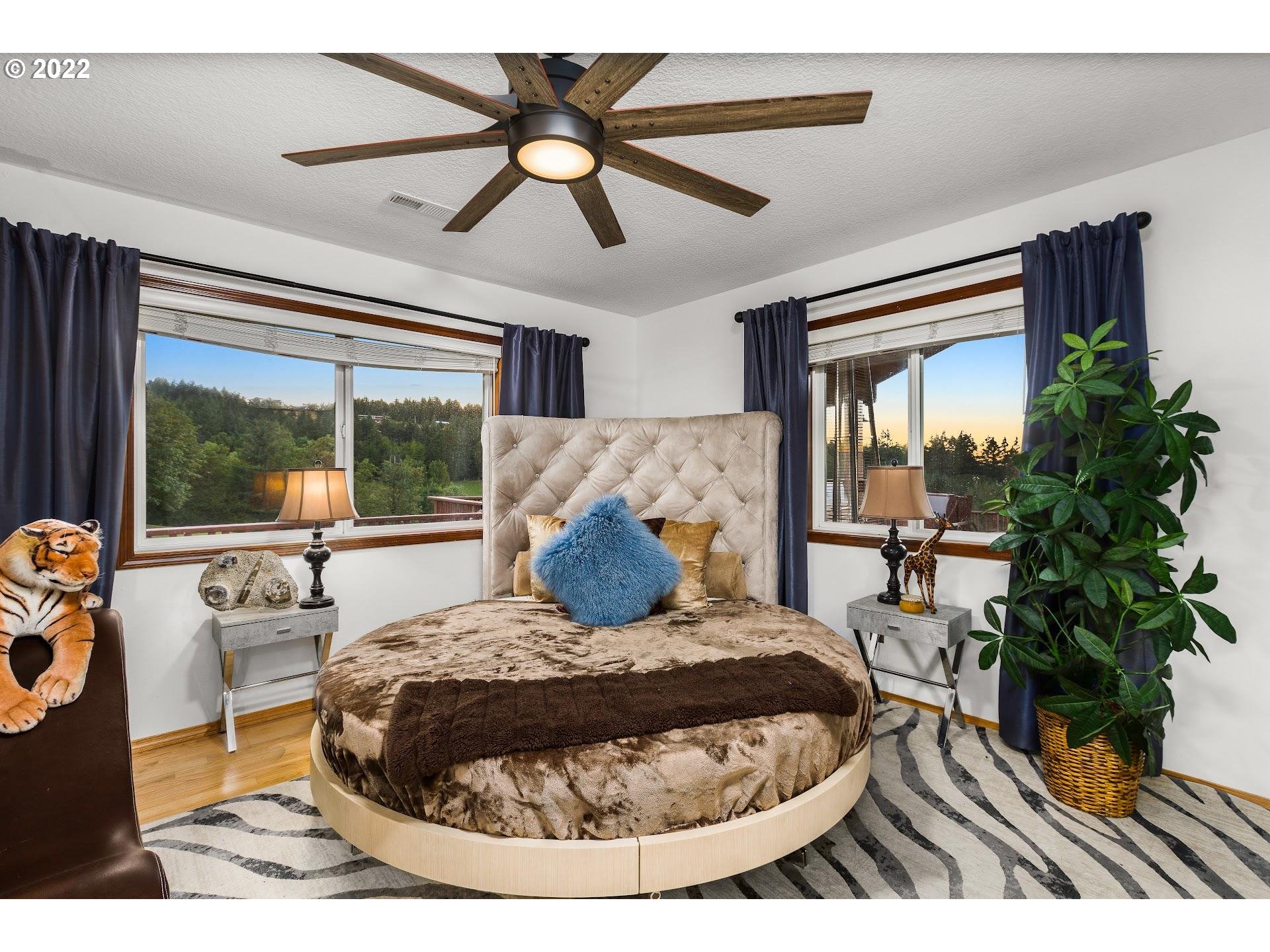 3995 Southwest Lafollett Road Cornelius, OR 97113 - Photo 12 of 32 a bed room with a bed window and a chandelier