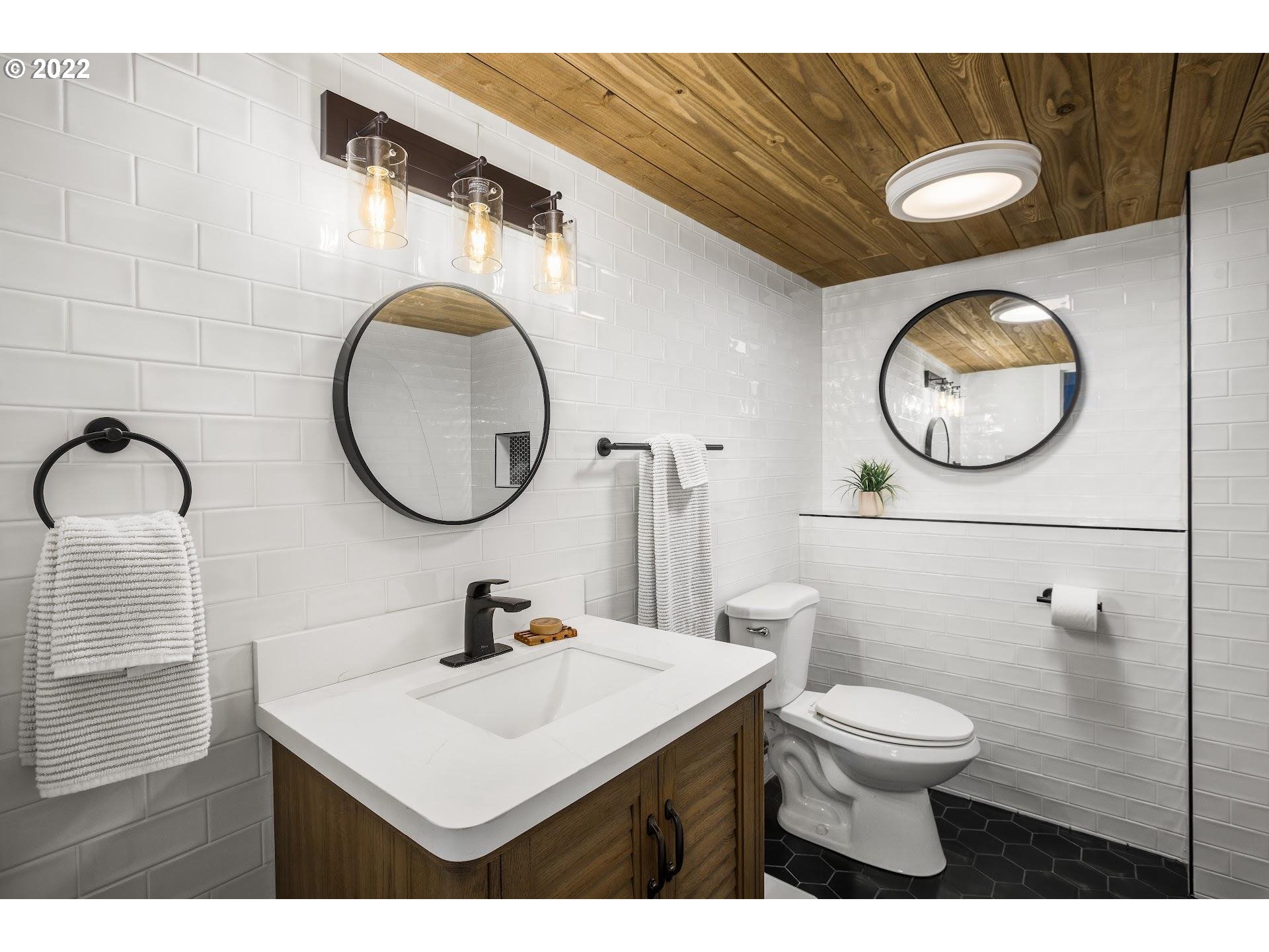 3995 Southwest Lafollett Road Cornelius, OR 97113 - Photo 16 of 32 a bathroom with a toilet sink vanity and mirror