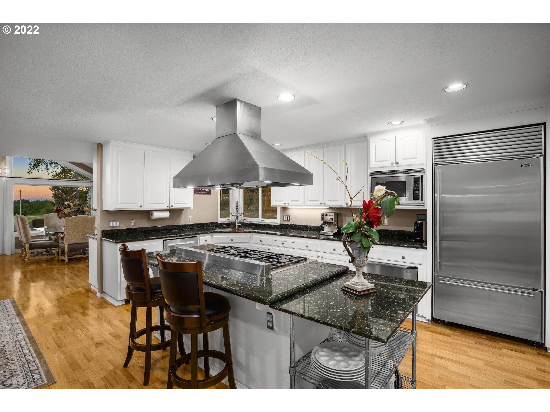 3995 Southwest Lafollett Road Cornelius, OR 97113 - Photo 8 of 32 a kitchen with kitchen island granite countertop a table and chairs in it