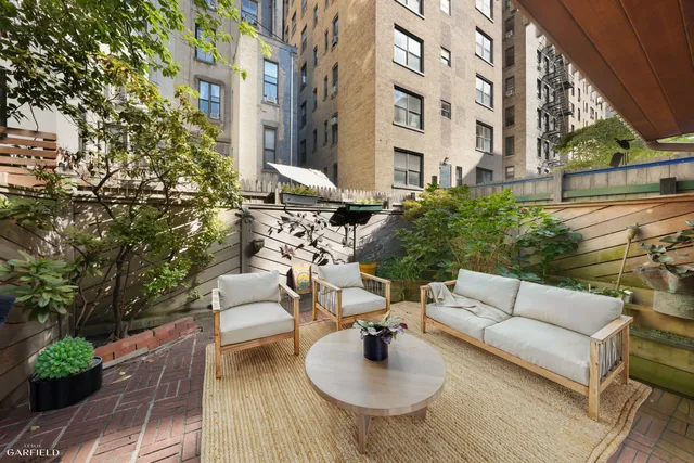 a bedroom with a bed and a flat tv screen on the dresser