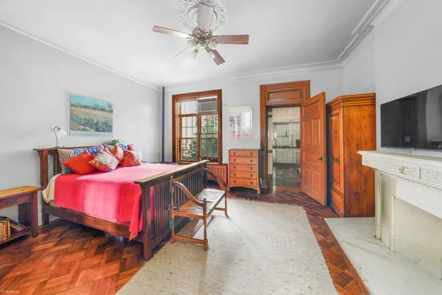 an empty room with windows and ceiling fan