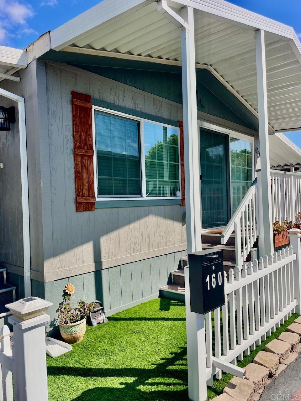 9902 Jamacha Boulevard, Unit 160 Spring Valley, CA 91977 - Photo 2 of 18 a front view of a house with garden