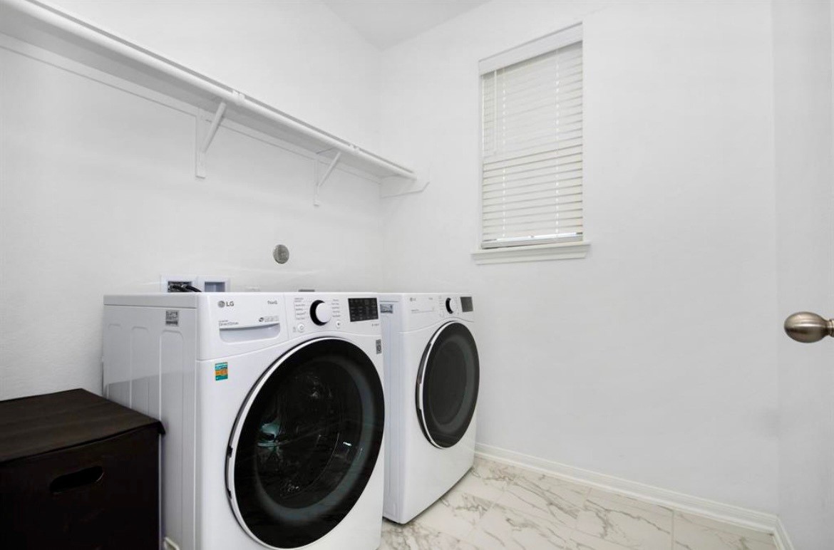 10406 Mount Winchell Drive Iowa Colony, TX 77583 - Photo 13 of 16 a utility room with dryer and washer