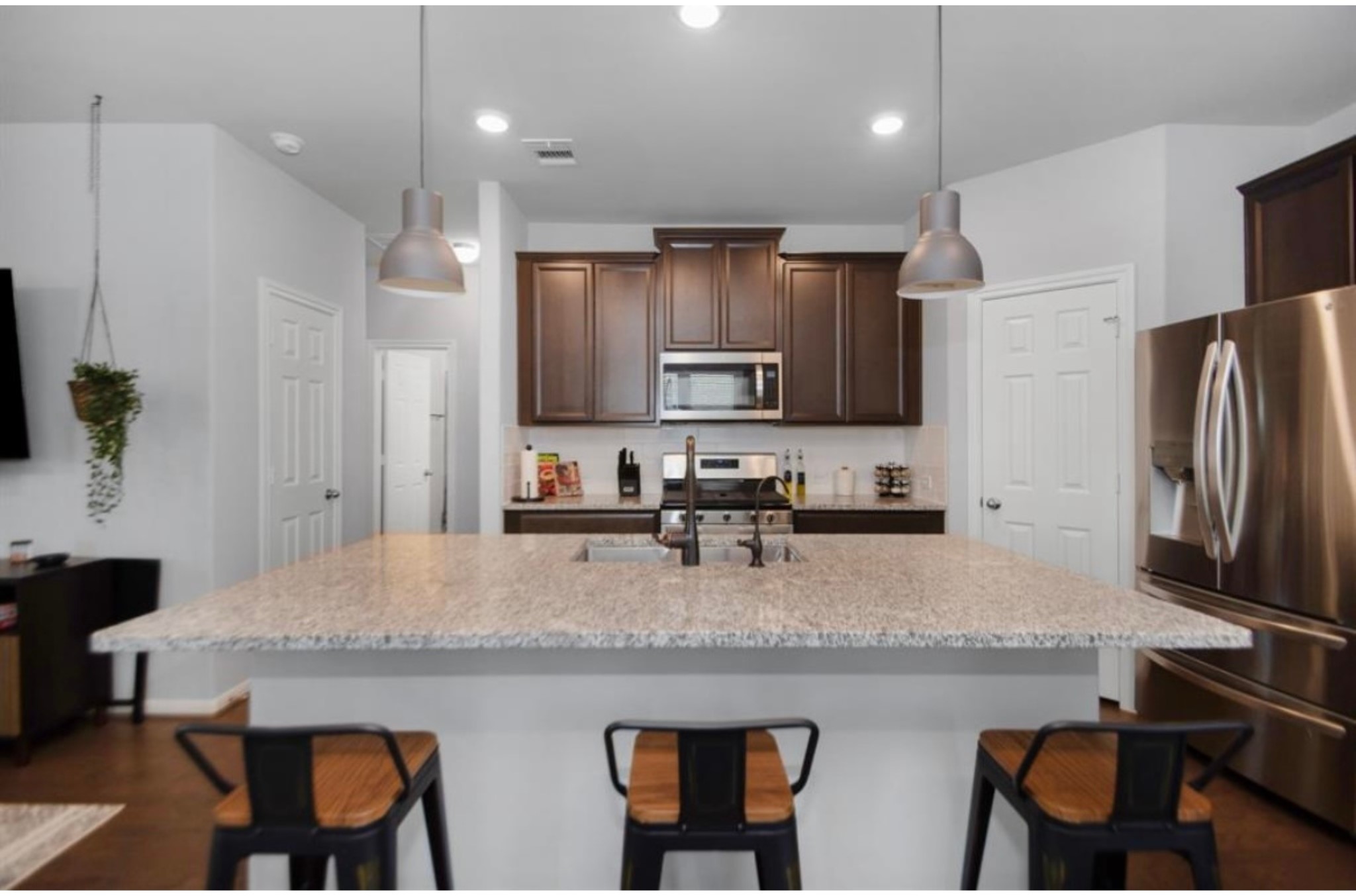 10406 Mount Winchell Drive Iowa Colony, TX 77583 - Photo 8 of 16 a kitchen with refrigerator a stove and a sink with wooden cabinets