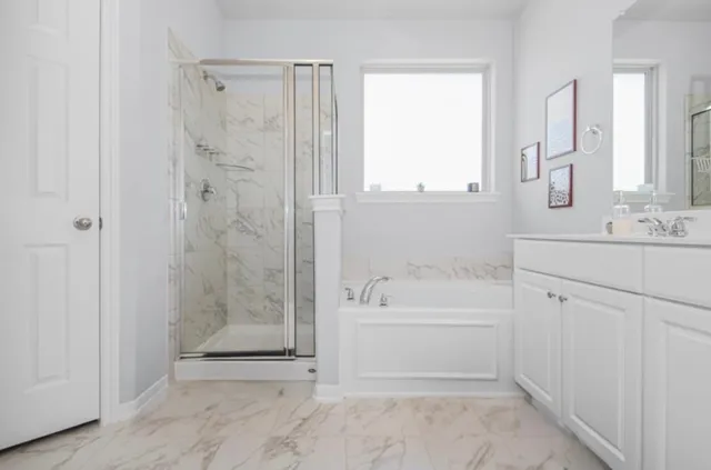 a spacious bathroom with a double vanity sink mirror and shower
